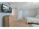 Inviting bedroom displaying dresser, TV, and a calming coastal color palette at 12924 Gulf Blvd # 502, Madeira Beach, FL 33708