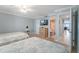 Relaxing bedroom with dresser, TV, and open entrance to ensuite bathroom at 12924 Gulf Blvd # 502, Madeira Beach, FL 33708