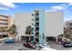 Exterior of a building with parking spots and trees at 12924 Gulf Blvd # 502, Madeira Beach, FL 33708