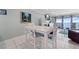 Bright dining room with a modern table set and view of the beach at 12924 Gulf Blvd # 502, Madeira Beach, FL 33708