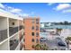 Condominium exterior featuring balconies, palm trees, a community pool, and parking at 12924 Gulf Blvd # 502, Madeira Beach, FL 33708