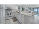Modern kitchen with a breakfast bar and tile flooring at 12924 Gulf Blvd # 502, Madeira Beach, FL 33708