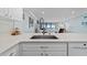 Open-concept kitchen with stainless steel sink and a view of the living area at 12924 Gulf Blvd # 502, Madeira Beach, FL 33708