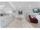 Open-concept kitchen and dining area with seating at 12924 Gulf Blvd # 502, Madeira Beach, FL 33708
