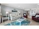 Relaxing living room leading to the kitchen and dining area with ocean decor at 12924 Gulf Blvd # 502, Madeira Beach, FL 33708