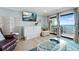Comfortable living room with balcony and ocean view, perfect for relaxing at 12924 Gulf Blvd # 502, Madeira Beach, FL 33708