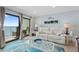 Relaxing living room with balcony access and coastal-themed decor at 12924 Gulf Blvd # 502, Madeira Beach, FL 33708