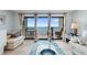 Cozy living room featuring balcony with ocean view and comfortable seating at 12924 Gulf Blvd # 502, Madeira Beach, FL 33708