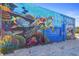Building exterior painted with a bright mural of ocean life, including turtles, fish, and coral reef with Madeira Beach text at 12924 Gulf Blvd # 502, Madeira Beach, FL 33708
