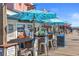 Charming outdoor bar on a wooden pier, featuring casual seating and scenic waterfront views at 12924 Gulf Blvd # 502, Madeira Beach, FL 33708