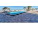 Resort-style pool with beautiful paver deck and sandy beach steps away from cool, clear water at 12924 Gulf Blvd # 502, Madeira Beach, FL 33708