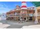 Two story restaurant building featuring a red and white lighthouse, with parking available and a gift shop at 12924 Gulf Blvd # 502, Madeira Beach, FL 33708