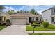 Charming single-story home featuring a well-manicured lawn, an attached garage, and tasteful landscaping at 12934 Tikal Way, Trinity, FL 34655
