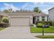 A charming single-story home boasts a two-car garage, well-maintained landscaping and mature flowering bushes at 12934 Tikal Way, Trinity, FL 34655