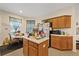 Cozy eat-in kitchen features ample counter space, wood cabinetry, and a dining area for casual meals at 12934 Tikal Way, Trinity, FL 34655