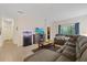 Comfortable living room with a gray sectional sofa, TV, and a decorative fish tank at 12934 Tikal Way, Trinity, FL 34655