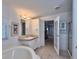 Bathroom with a jacuzzi-style tub, neutral tiling, vanity, and adjacent walk-in shower at 131 E Saint Annes Cir, Apollo Beach, FL 33572