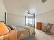 Main bedroom with a four-poster bed, a ceiling fan, and large windows at 131 E Saint Annes Cir, Apollo Beach, FL 33572