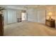 Spacious bedroom features neutral walls, carpet, closet doors, and access to an en-suite bathroom at 131 E Saint Annes Cir, Apollo Beach, FL 33572