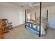 Comfortable bedroom features a rocking chair, closet, ceiling fan, and a four-poster bed at 131 E Saint Annes Cir, Apollo Beach, FL 33572
