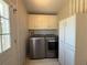 Convenient laundry room with modern washer and dryer, and ample cabinet storage at 131 E Saint Annes Cir, Apollo Beach, FL 33572