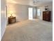 Bright living room featuring neutral walls, carpet floors, ceiling fan, and two decorative wood cabinets at 131 E Saint Annes Cir, Apollo Beach, FL 33572