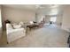 Spacious living room with neutral carpet, comfortable seating, and ample natural light at 131 E Saint Annes Cir, Apollo Beach, FL 33572