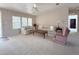 Bright living room featuring carpet, large windows, comfortable sofas, and ample space at 131 E Saint Annes Cir, Apollo Beach, FL 33572