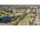 Stunning aerial view of the lush green golf course, with serene lakes and mature trees at 16323 Muirfield Dr, Odessa, FL 33556