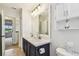 Bright bathroom featuring a double vanity with a white countertop and a framed mirror at 16323 Muirfield Dr, Odessa, FL 33556