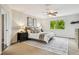 Comfortable bedroom featuring a queen bed, a ceiling fan, and a window with a lush green view at 16323 Muirfield Dr, Odessa, FL 33556