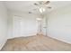 Bedroom with neutral carpet and walls with connected hallway and large closet at 16323 Muirfield Dr, Odessa, FL 33556