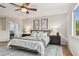 Comfortable bedroom featuring a queen bed, two nightstands, and access to bathroom at 16323 Muirfield Dr, Odessa, FL 33556