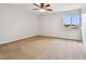 Bedroom featuring neutral walls, carpet, a ceiling fan, and a large window at 16323 Muirfield Dr, Odessa, FL 33556