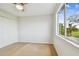 Bedroom with neutral walls, carpet, a window with scenic view, and closet at 16323 Muirfield Dr, Odessa, FL 33556
