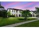 Beautiful two-story home featuring a well-manicured lawn, mature trees, and a two-car garage at 16323 Muirfield Dr, Odessa, FL 33556