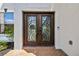 Close-up of an elegant double front door with decorative ironwork and a brick entrance at 16323 Muirfield Dr, Odessa, FL 33556