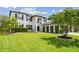 Beautifully landscaped front yard with lush lawn and meticulously maintained hedges complements the home's architecture at 16323 Muirfield Dr, Odessa, FL 33556