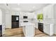 Beautiful kitchen with center island, stainless steel appliances, and bright lighting at 16323 Muirfield Dr, Odessa, FL 33556