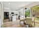Bright eat-in kitchen featuring white cabinetry, an island, stainless appliances, and outdoor view at 16323 Muirfield Dr, Odessa, FL 33556