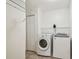 Efficient laundry room featuring modern appliances, tiled floor and built-in shelving at 16323 Muirfield Dr, Odessa, FL 33556