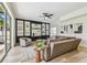 Open concept living room featuring a large sectional sofa and a black built-in bookcase at 16323 Muirfield Dr, Odessa, FL 33556