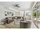 Open concept living room with hardwood floors, neutral paint, and view to screened outdoor space at 16323 Muirfield Dr, Odessa, FL 33556