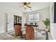 Well-lit home office with modern furnishings, a decorative rug, and natural light at 16323 Muirfield Dr, Odessa, FL 33556