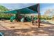 Community playground featuring a covered play structure, slides, benches, and wood chip ground cover at 16323 Muirfield Dr, Odessa, FL 33556