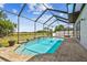 A screened-in pool with brick pavers and tranquil views of the fenced-in backyard at 16323 Muirfield Dr, Odessa, FL 33556