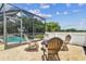 The patio area offers a nice outdoor living area with fire pit and view of the screened pool at 16323 Muirfield Dr, Odessa, FL 33556