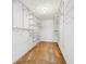 Spacious walk-in closet with ample shelving and storage space at 16323 Muirfield Dr, Odessa, FL 33556