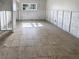 Spacious living room featuring tiled floors, large windows, and unfinished walls at 1715 Delaware Ne Ave, St Petersburg, FL 33703
