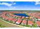 Beautiful aerial view of the community, showcasing the homes, lake, and landscaping at 17214 Star Banks St, Wimauma, FL 33598